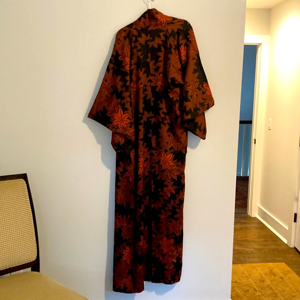 Long vintage kimono featuring orange leaf pattern on black satin.